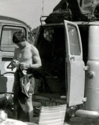 motorcyle racer in 1970 man with van preparing motorcycle for racing